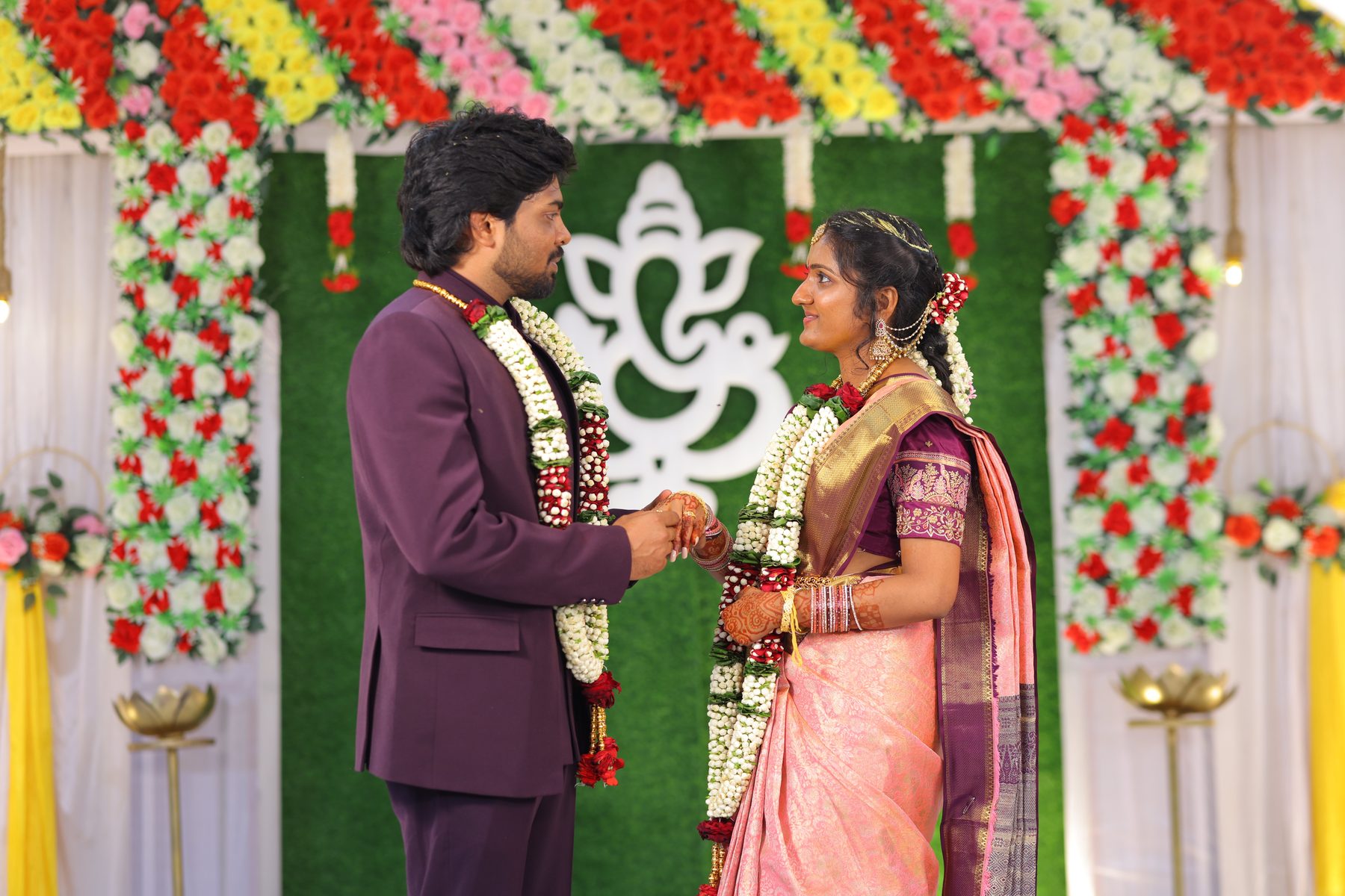 Teja placing a ring on Lekha's hand as they face each other at the mandap