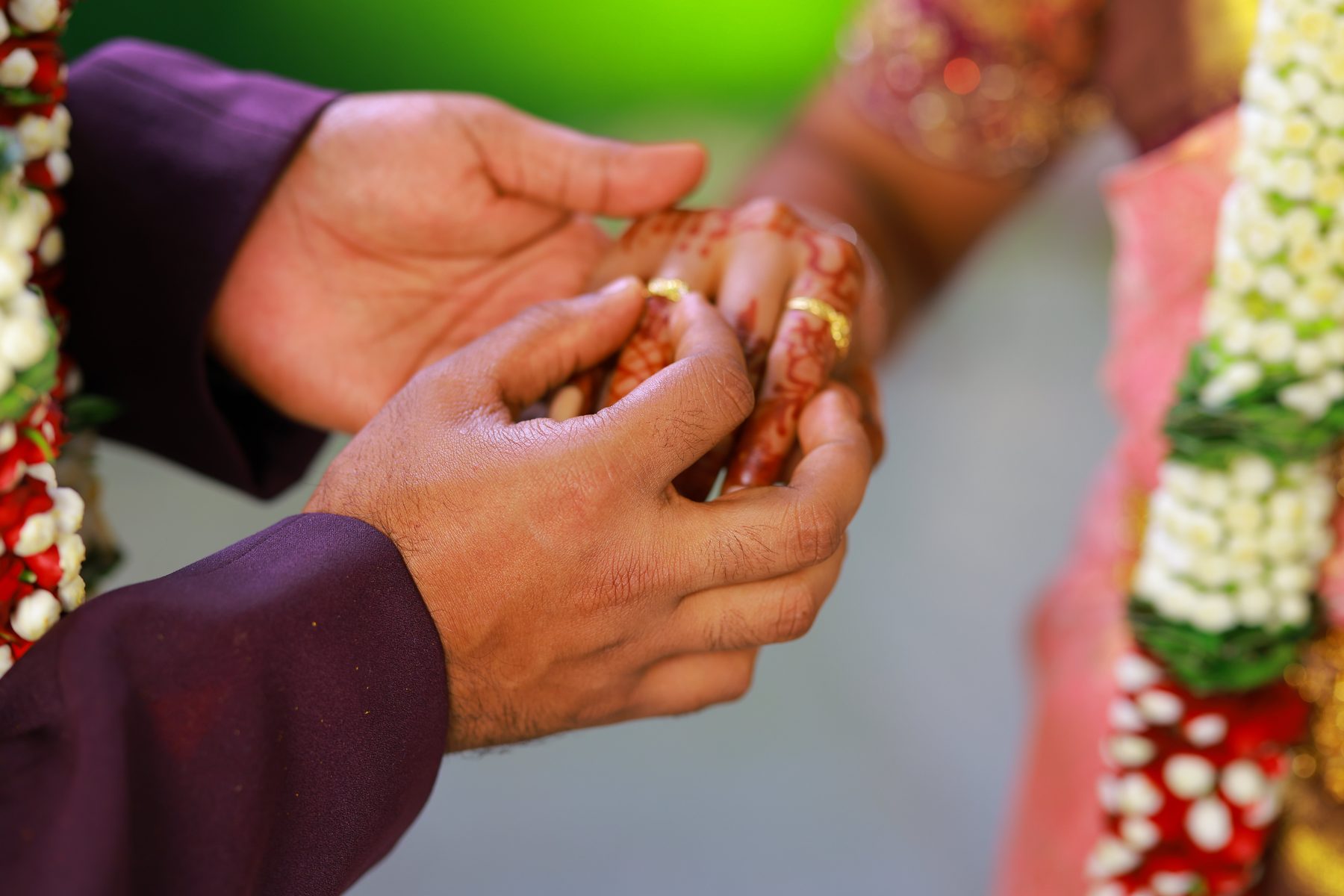 Close-up of the ring being placed on Lekha's hand