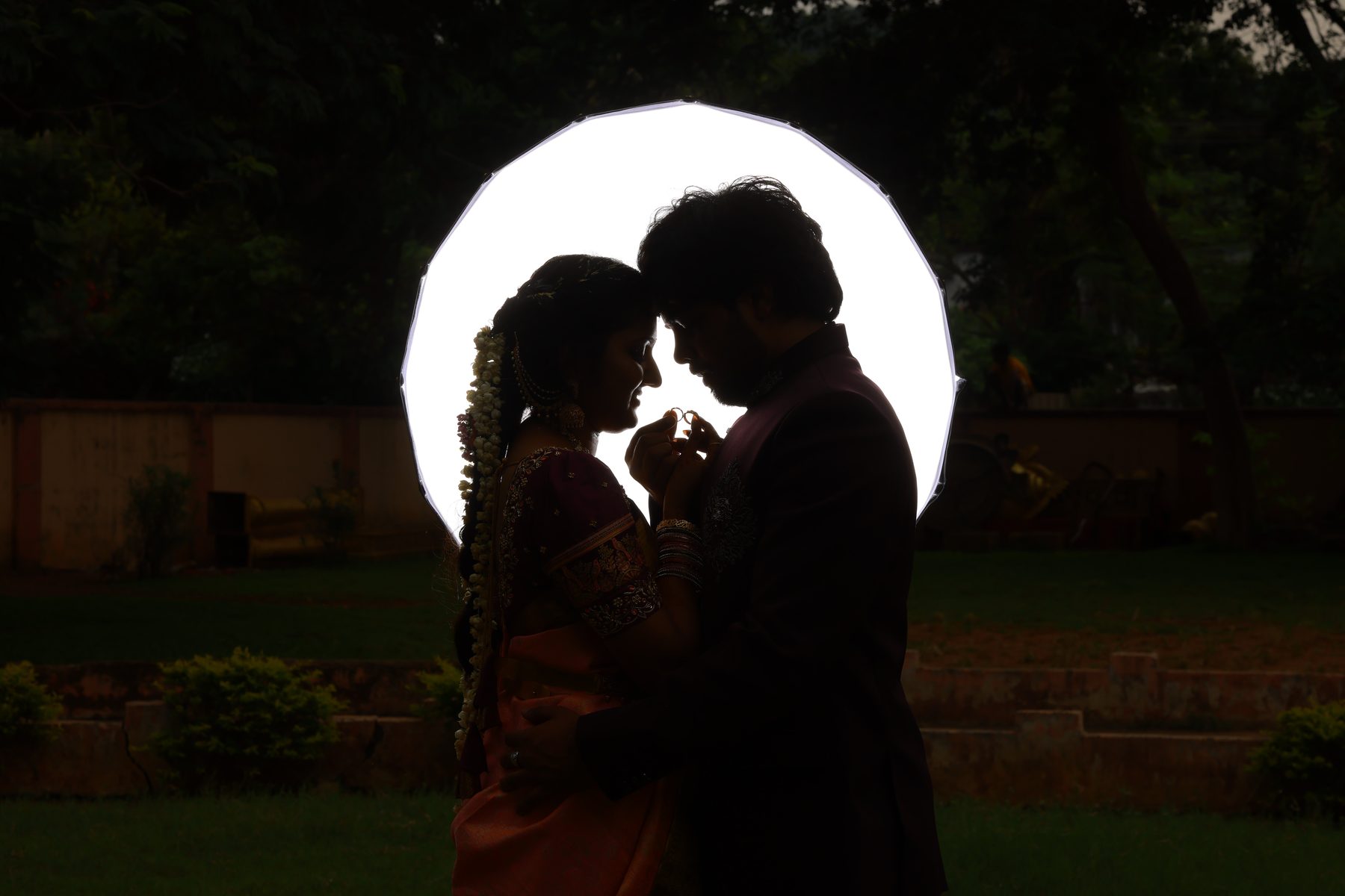 Teja and Lekha in silhouette, foreheads touching